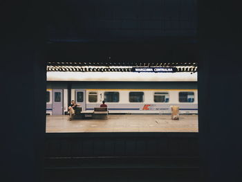 View of railroad station platform through window