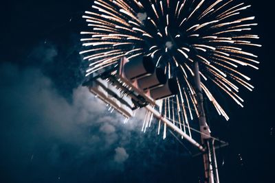 Low angle view of firework display at night