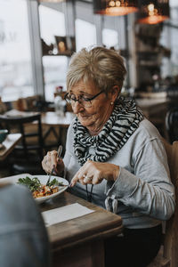 Woman having meal in cafe