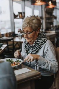 Woman sitting on table at restaurant