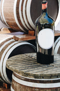 High angle view of wine bottle on barrel