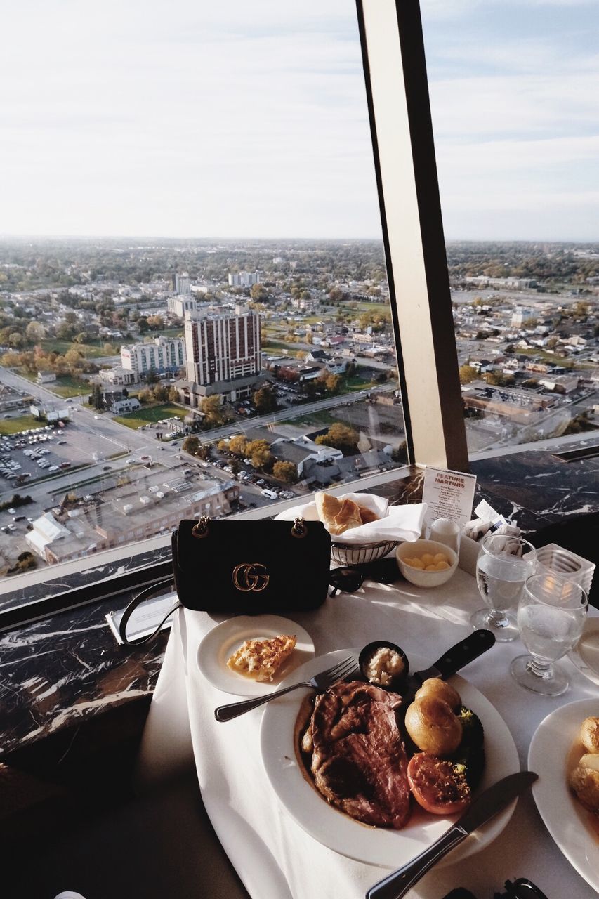 food and drink, food, plate, freshness, city, high angle view, architecture, no people, table, building exterior, window, built structure, day, drink, coffee, water, cityscape, refreshment, nature, meal, breakfast, crockery