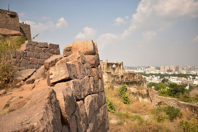 Old buildings in city against sky