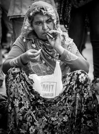 Woman smoking cigarette outdoors