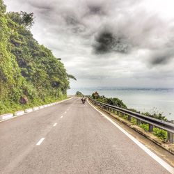 Road by sea against sky