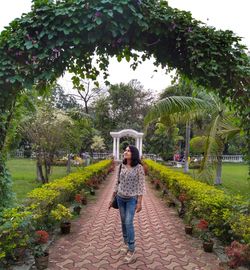 Woman standing on footpath in park