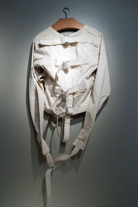 Close-up of straight jacket hanging