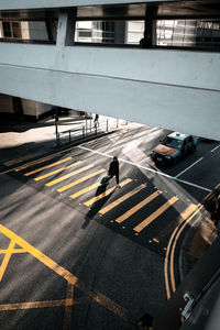 High angle view of man crossing road
