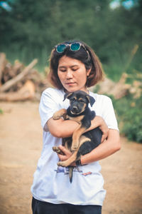 Portrait of woman holding dog