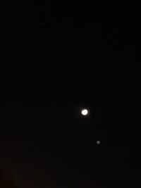 Low angle view of moon against sky at night
