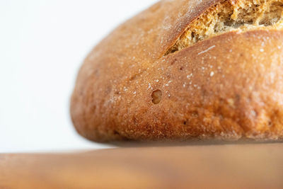 Close-up of bread on table against white background