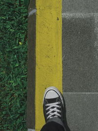 Low section of person standing on footpath