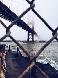 Close-up of suspension bridge in city