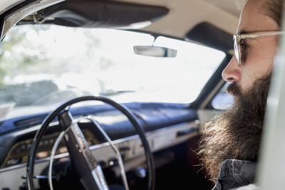 Handsome young man sitting in a car