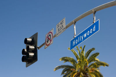 Low angle view of information sign against clear sky