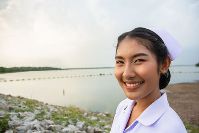 Smiling young nurse on field