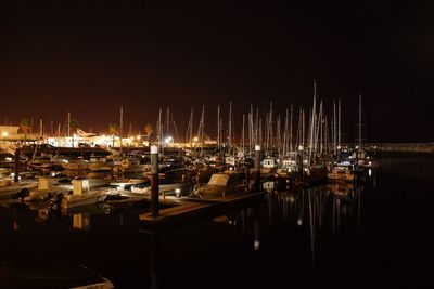 Sailboats in marina at night