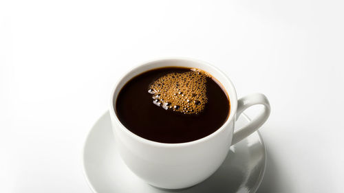 High angle view of coffee cup against white background