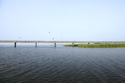 Bridge over lake against sky