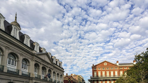 Low angle view of building against cloudy sky