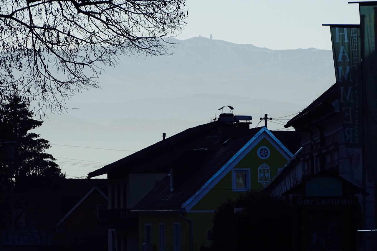 HOUSES ON MOUNTAIN AGAINST CLEAR SKY