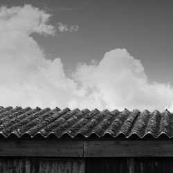 Low angle view of roof tiles against sky