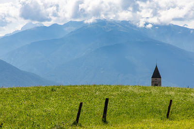 Scenic view of green mountains against sky