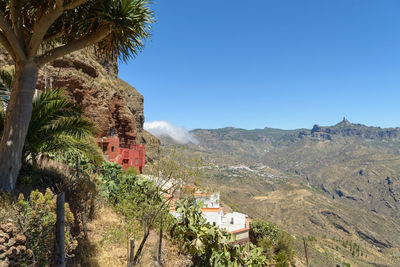 Scenic view of mountains against clear blue sky