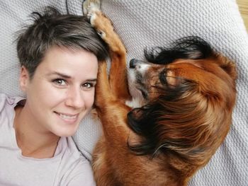 Portrait of smiling young woman with dog