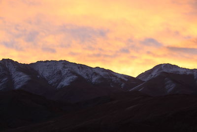 Scenic view of mountains against sky during sunset