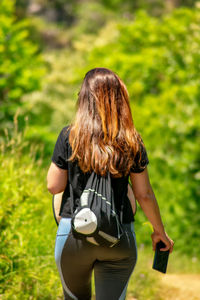 Rear view of woman standing on field