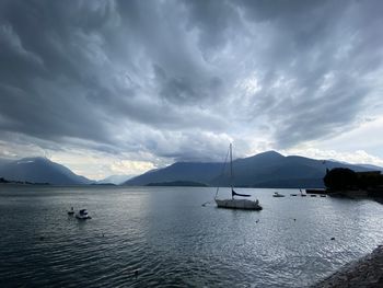 Sailboats in sea against sky