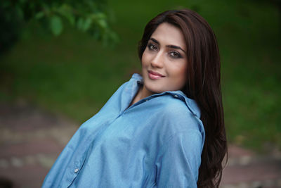 Portrait of young woman standing outdoors