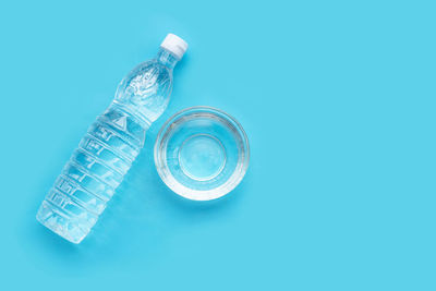 Close-up of glass bottle against blue background