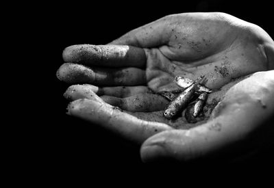 Close-up of human hand against black background