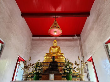 Low angle view of statue against illuminated building