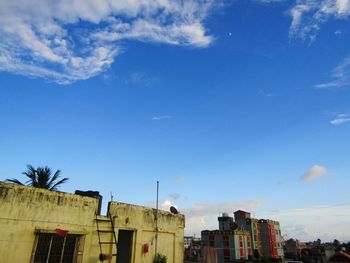 Low angle view of residential buildings against blue sky