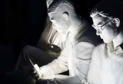 Midsection of man holding woman sitting at home