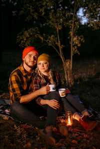 Young man and woman sitting in traditional clothing