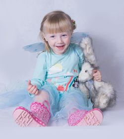 Portrait of cute girl playing with dog