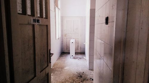 Open door of abandoned public restroom