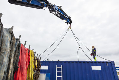 Woman assisting with carrying cargo container