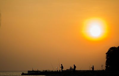 Scenic view of sea against orange sky