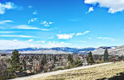 Scenic view of snowcapped mountains against blue sky