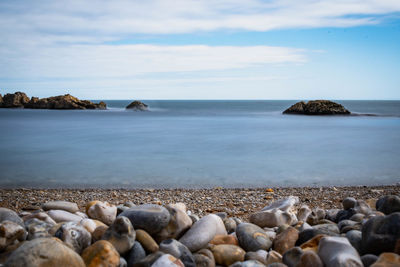 Rocks on beach against sky