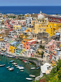 High angle view of townscape by sea against sky