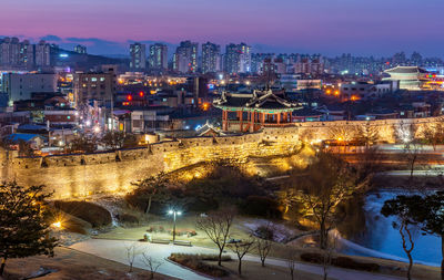 High angle view of illuminated buildings in city at night