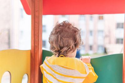 Portrait of boy with yellow umbrella