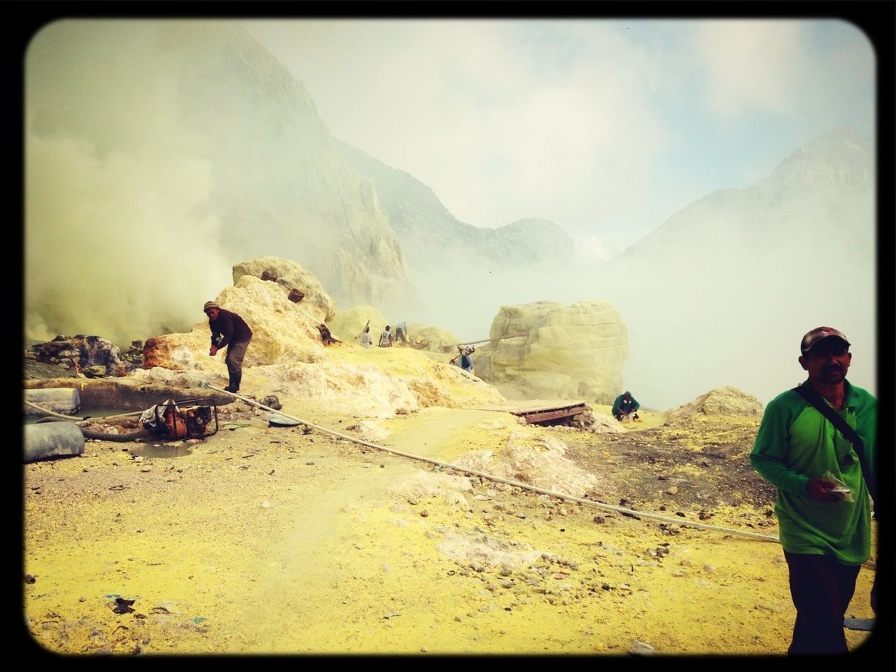 transfer print, sky, lifestyles, mountain, leisure activity, men, auto post production filter, cloud - sky, full length, tourist, rock - object, scenics, person, travel, vacations, nature, casual clothing, tourism