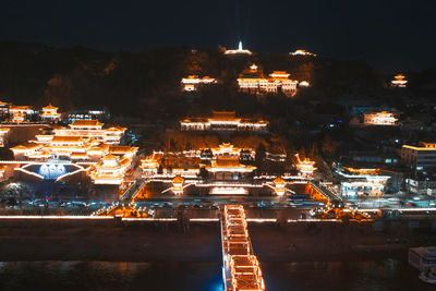 High angle view of illuminated buildings in city at night